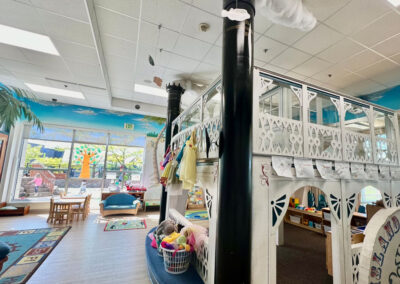 A picture of a thematically decorated Kids Junction classroom with a large white loft in the middle of the room for kids to play on.