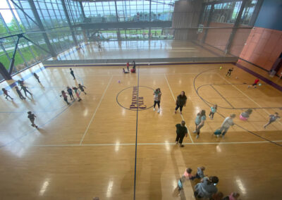 A picture from above the Princeton Club gymnasium with students playing various games and sports below.